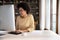 Happy young Black student girl in glasses working at desktop