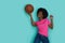 Happy Young Black Woman With Arfo Hair Is Playing With Basketball Ball