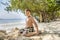 Happy young boy is digging in the sand of the beach