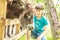 Happy young boy feeding donkey on farm