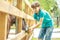 Happy young boy feeding donkey on farm