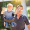 Happy Young Boy Having Fun On The Swings With His Father