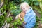 Happy young boy holding a home grown organic pumpkin