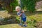 Happy young boy with playful smile in garden during summer sunshine