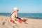 Happy young boy reading a book on a sunny dayl. boy sitting Sad with his back at the beach. Last day of vacation. Back to school.