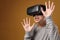 Happy young boy wearing virtual reality VR goggles watching movies or playing video games.  Funny child experiencing 3D gadget