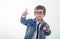 Happy young boy in white t-shirt and jeans jacket thinking and looking up with red clock pointing finger up on white background.