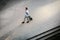 Happy Young Businessman Walking with Suitcase in the City. Modern Male in Business Trip. High Angle View.