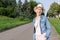 Happy young caucasian bald woman in hat and casual clothes enjoying life after surviving breast cancer. Portrait of