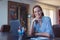 Happy young Caucasian businesswoman toothy smile at laptop