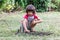 Happy young child learning to build with twigs and feathers