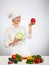 Happy young cook holding head of savoy cabbage