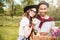 Happy young couple with basket of drinks, food and flowers