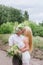 Happy young couple with a bouquet and a wreath embracing and kissing