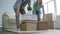 Happy young couple with cardboard boxes moves to new apartment