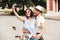 Happy young couple in crash helmets making selfie on smartphone