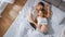 Happy Young Couple Cuddling Together in the Bed, Young Woman is Pregnant and Loving Partner Touche