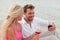 Happy Young Couple Drinking Red Wine Outdoors Beach