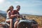 Happy young couple driving a quad bike