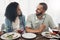 Happy young couple eating lunch with wine for celebration of love, holiday or valentines with conversation. Mexico