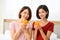 Happy young couple friend beautiful asia women drinking orange juice enjoying fruit refreshment ,Healthy lifestyle concept