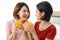 Happy young couple friend beautiful asia women drinking orange juice enjoying fruit refreshment ,Healthy lifestyle concept