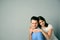 Happy young couple on gray background