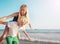 Happy young couple having fun at beach on sunny day