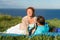 Happy young couple having fun outdoors and smiling. Beautiful couple laying on beach in the evening.