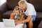 Happy young couple looking at laptop