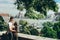Happy young couple in love is gently hugging on the balcony at the background of Budapest panorama in Hungary.