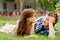 Happy young couple in love lying on green grass