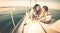 Happy young couple in love on sail boat having fun with tablet