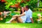 Happy young couple in love sitting near pond with flamingo