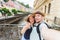 Happy young couple in love takes selfie portrait in Karlovy Vary in Czech Republic. Pretty tourists make funny photos