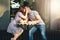 Happy young couple in love teenagers friends dressed in casual style kissing in street cafe