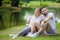 Happy young couple loving fitness in sportswear relaxing at park together in morning time. sport people sitting taking a break