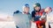 Happy young couple man and woman snowboarders on background of ski resort sun day. Concept Banner winter sport travel