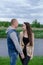 happy young couple outdoors near lake and green grass. bald man and brunette woman. husband and wife. millennials