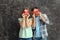 Happy young couple with red hearts on grunge background