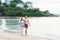 Happy young couple romantic lifestyle walking on tropical beach