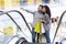 Happy young couple with shopping bags rising on escalator