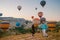 happy young couple during sunrise watching the hot air balloons of Kapadokya Cappadocia Turkey