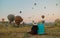 happy young couple during sunrise watching the hot air balloons of Kapadokya Cappadocia Turkey