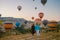 happy young couple during sunrise watching the hot air balloons of Kapadokya Cappadocia Turkey