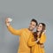 Happy young couple in warm clothes taking selfie. Winter season