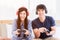 Happy young couple wear headphone and holding joystick playing video game