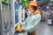 Happy young customer woman buys and pays for a bottle of orange juice at the checkout of a self