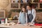 Happy young dad and little daughter baking pie in kitchen, checking recipe