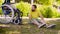 Happy young disable man sitting on the grass in the park